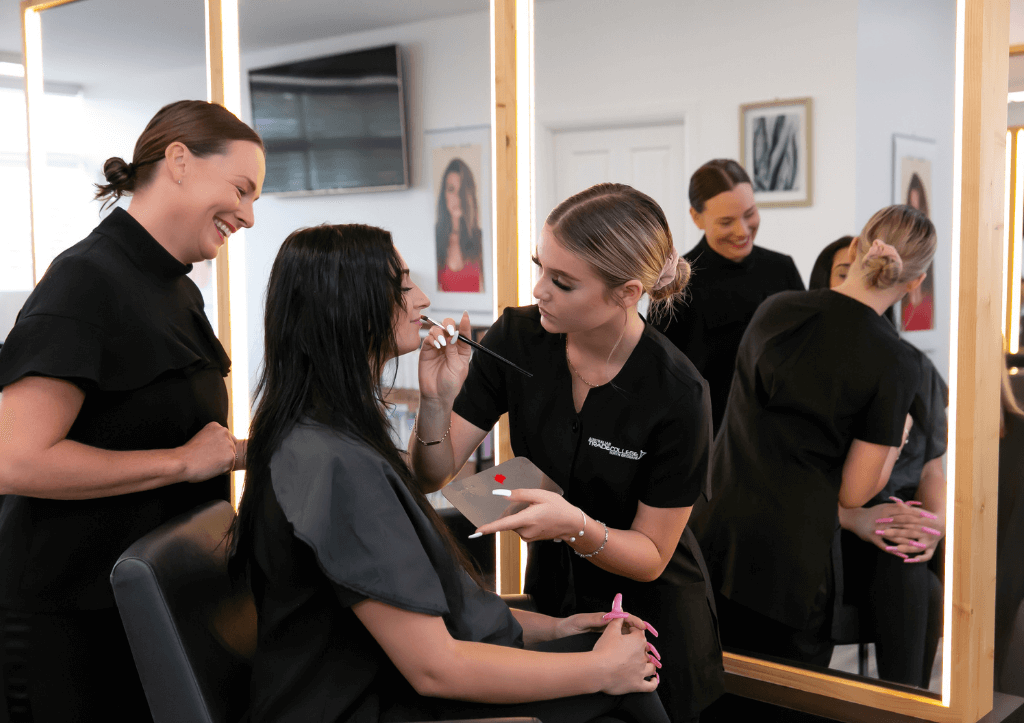 ATCNB applying lipstick to client with trainer