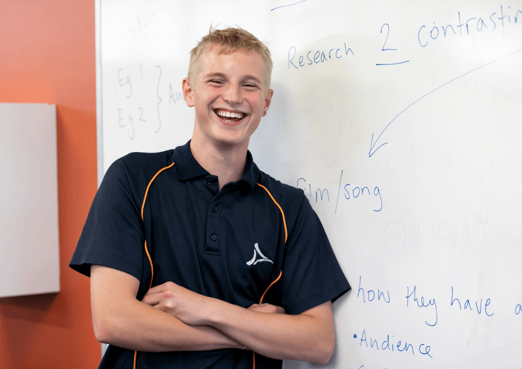 ATCNB student leaning on whiteboard