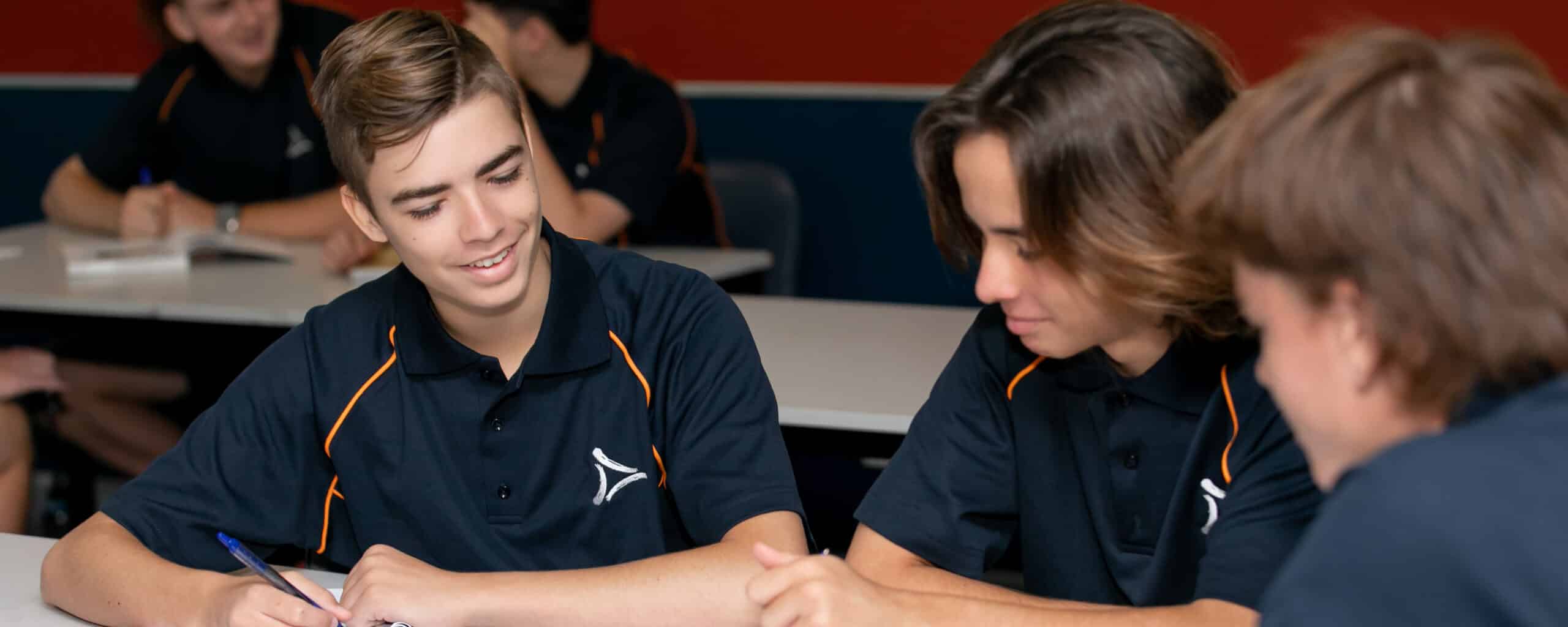 Three male trade college students studying General Mathematics